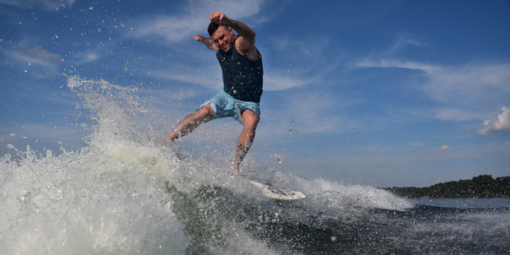 wakesurfer doing trick on doomswell board